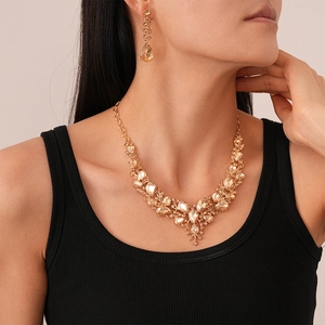 Luxurious champagne crystal V-shape drop jewelry set with necklace and earrings on model