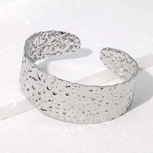Polished silver stainless steel wide open cuff bracelet with irregular hammered texture