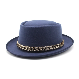 Close-up of a navy wool felt boater hat with a chunky gold chain band detail