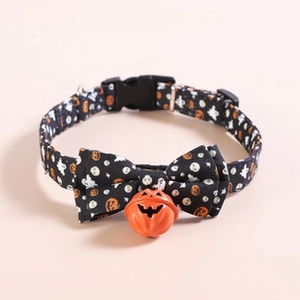 Detail of Halloween pet collar with pumpkin bell and spooky patterns on black fabric