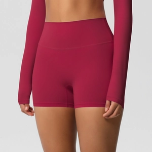 Detail view of high-waist seamless compression yoga shorts in deep wine red fabric