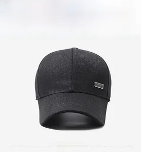 Detail of dark grey baseball cap with metal SPORT plaque and curved brim for outdoor wear