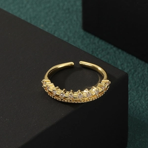 Elegant gold-plated copper ring with micro-paved zircons on a professional black stand