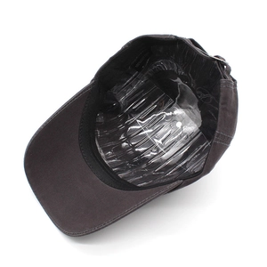 Detail view of cotton baseball cap interior with sweatband and 100% cotton label
