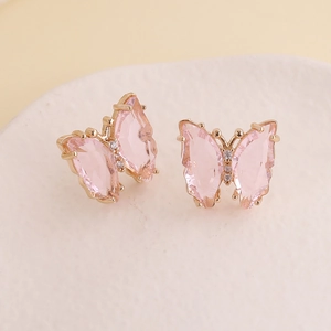 Close-up of pink butterfly earrings with gold plating and white zircon inlay details