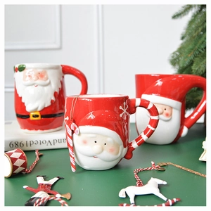 Close-up of 3D embossed Santa Claus ceramic mug with festive red handle and details