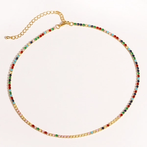 Detailed close-up of a golden tennis necklace with colorful zircon stones and extender chain