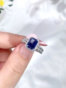 Close-up of 925 sterling silver ring with emerald-cut blue zircon and beaded band