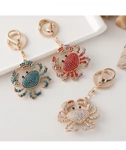 Detail of colorful crystal crab keychains with gold-tone lobster claws and keyrings