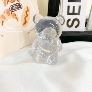 Detailed close-up of a holographic laser cartoon bear phone stand with aurora gradient effect
