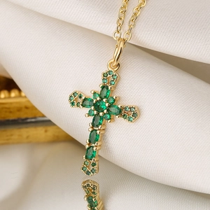 18K gold plated cross pendant necklace featuring emerald green zircon stones on white silk