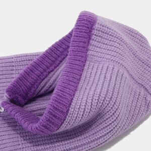Macro shot of purple knitted balaclava showing ribbed edges and detailed stitch texture