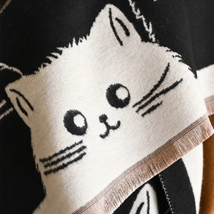 Black and white knit cat scarf with tassel edges and thick warm cashmere-like texture