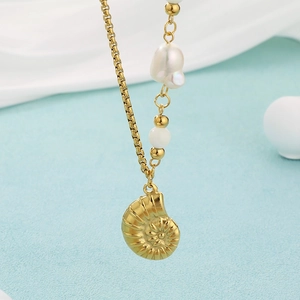 Detail of 18K gold-plated necklace with turquoise beads, shell and pearl charms