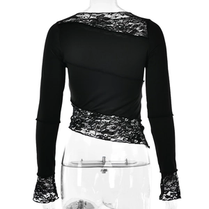 Detail of black long sleeve top featuring intricate lace patchwork on the back and hem