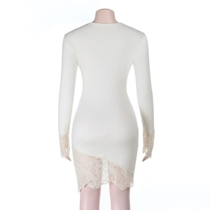 Detail view of the elegant lace hem and knitted fabric on the white bodycon dress