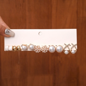 Detail of 6-pair gold stud earring set featuring pearls and rhinestones on card