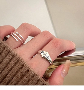 Close-up of S925 sterling silver bamboo joint ring and engraved shield ring set