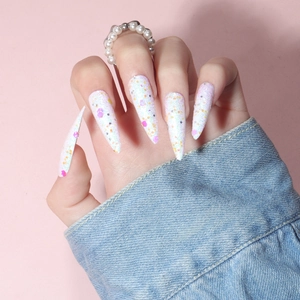 Detail view of long stiletto press-on nails with colorful sequins and fine glitter