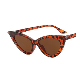 Retro cat-eye tortoiseshell sunglasses with dark brown lenses and silver rivet accents