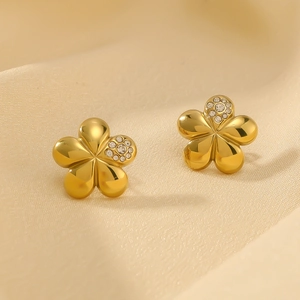 Vintage 18k gold plated flower stud earrings with zirconia on beige silk fabric
