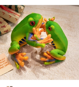 Detail of green plush frog dolls with orange striped limbs on a cozy carpet