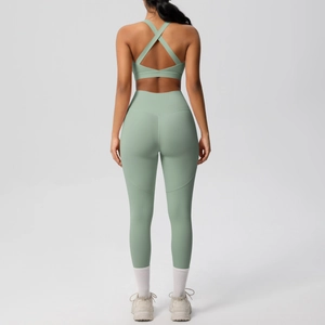 Rear view of mint green high-waisted yoga pants and criss-cross back sports bra