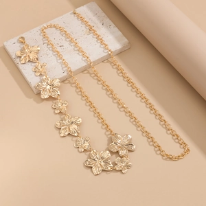 Detail view of golden flower and starfish alloy waist chain on marble texture