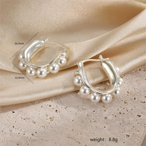 Detail view of silver pearl hoop earrings with measurements 24.3mm and weight 8.8g