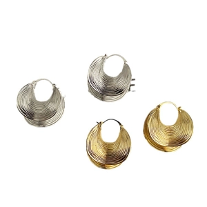 Irregular textured brass hoop earrings in gold and silver finish with moon shape design