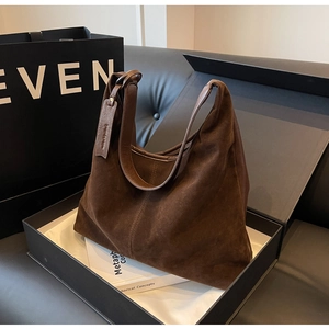 Brown faux suede tote bag displayed in a gift box with aesthetic accessories