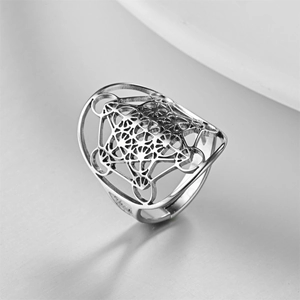 Detail view of silver stainless steel ring with hollow sacred geometry pattern