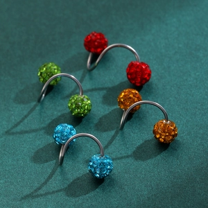 Macro detail of spiral surgical steel piercings with colorful rhinestone-encrusted balls