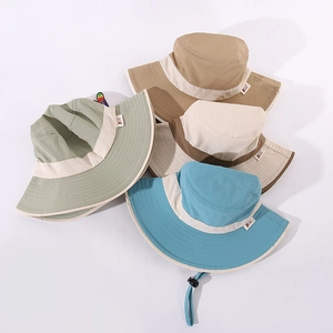 Detailed view of colorful wide-brim kids bucket hats with contrast edges and windproof ropes