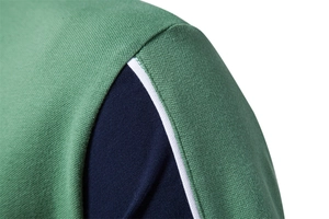 Close-up of green and blue polo shirt showing premium pique mesh fabric and stitching