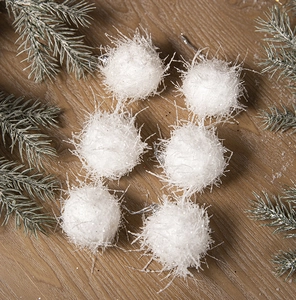 Close-up of white plush Christmas ornaments with glitter and silver hanging strings