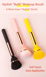 Close-up of bulb-shaped makeup brushes with soft bristles in black, pink, and yellow
