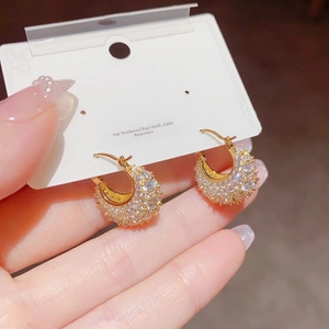 Macro view of 14K gold plated hoop earrings with micro-paved sparkling cubic zirconia