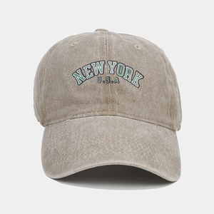 Close-up of vintage washed khaki baseball cap with New York USA green embroidery detail
