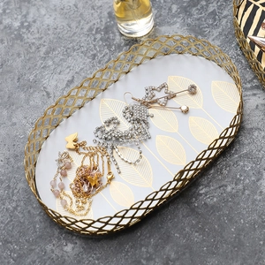 Nordic oval gold iron wire jewelry tray with white base and golden leaf pattern design