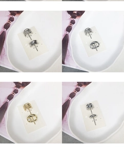 Close-up of minimalist gold and silver metal hair clips with pearl details on display
