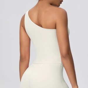 Rear view of ivory yoga sports set showing one-shoulder design and slimming back detail