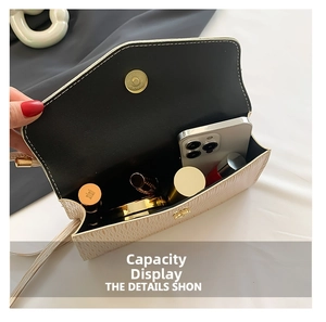 Internal view of cream textured crossbody bag showing capacity for phone and makeup