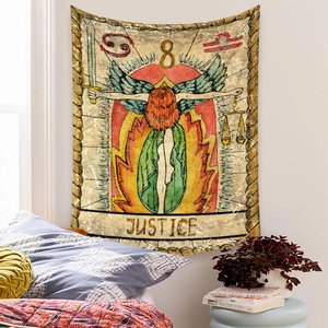 Detail of vintage Justice tarot tapestry hanging over a bed in a cozy bedroom