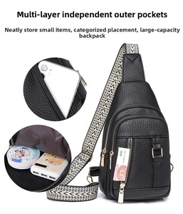 Detailed view of the multi-layer interior compartments in black pebbled leather chest bag