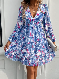 Detail of V-neckline and colorful floral pattern on this elegant long sleeve mini dress