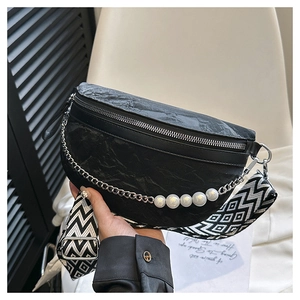 Detail of black wrinkled texture chest bag with pearl chain and geometric strap