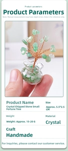 Close-up of a mini handmade crystal money tree with lucky bag base held by hand