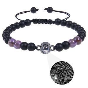Detail showing projection stone lens displaying I Love You in 100 languages on bead bracelet