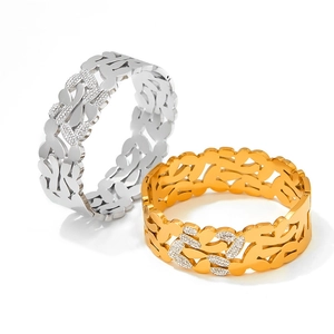 Detail of hollow vine pattern bracelets in gold and silver with sparkling crystals